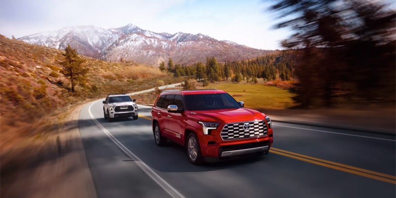 Two new 2023 Toyota Sequoia's driving up beautiful mountainous forestry highways