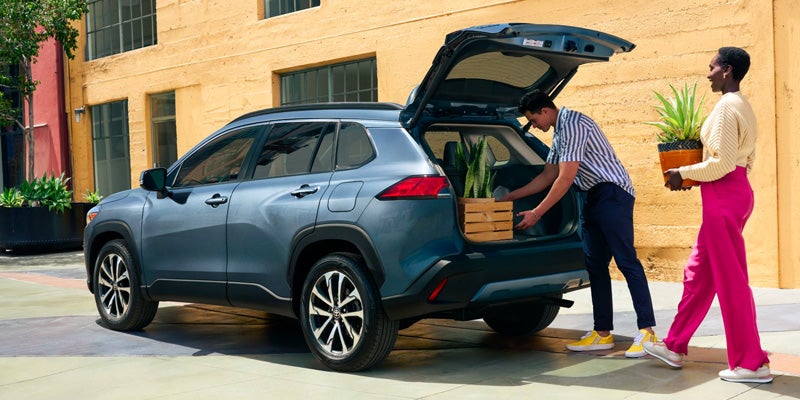 A 2024 Toyota Corolla Cross Hybrid owner packing the trunk of their car.