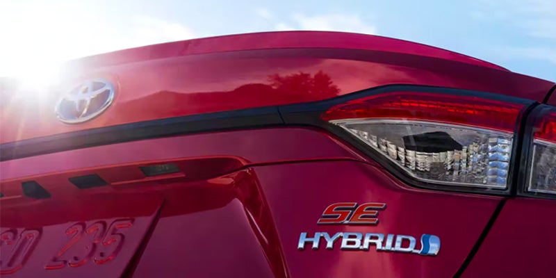 The back of a 2024 Toyota Corolla Hybrid with the Hybrid emblem.