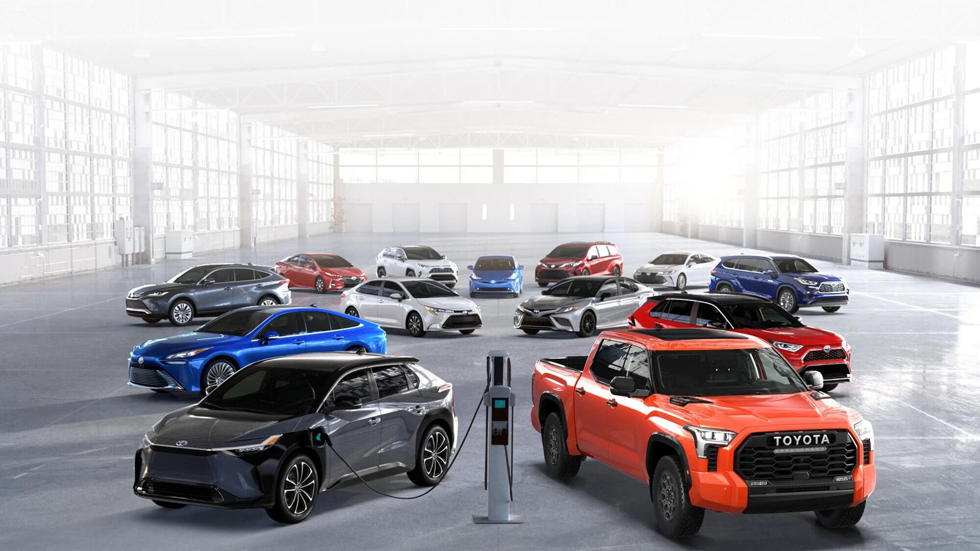 Toyota vehicles displayed in a modern showroom with a mix of cars, SUVs, and electric models.